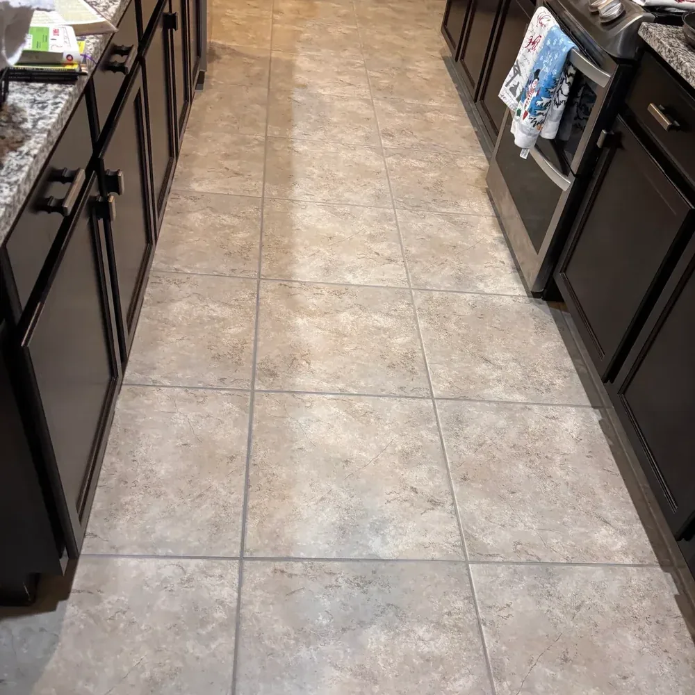 Tile kitchen floor with clean grout lines after professional cleaning