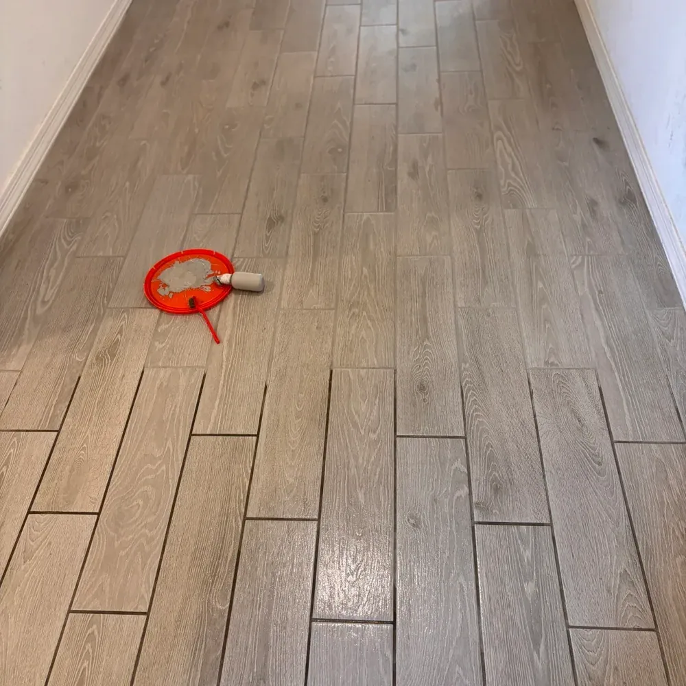 Tile floor during grout color sealing